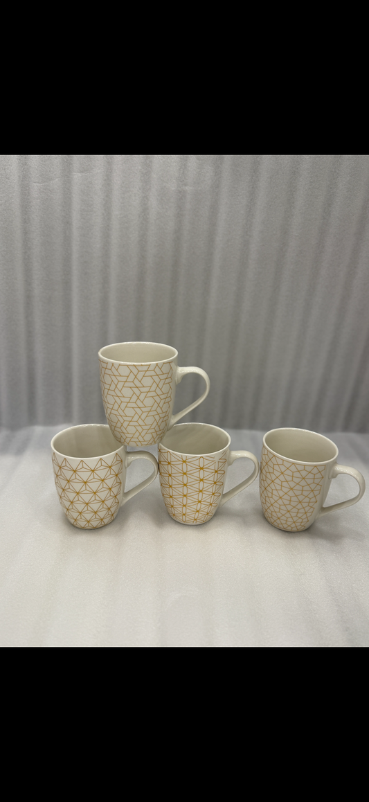 Light-toned porcelain mugs with a geometric metallic design,