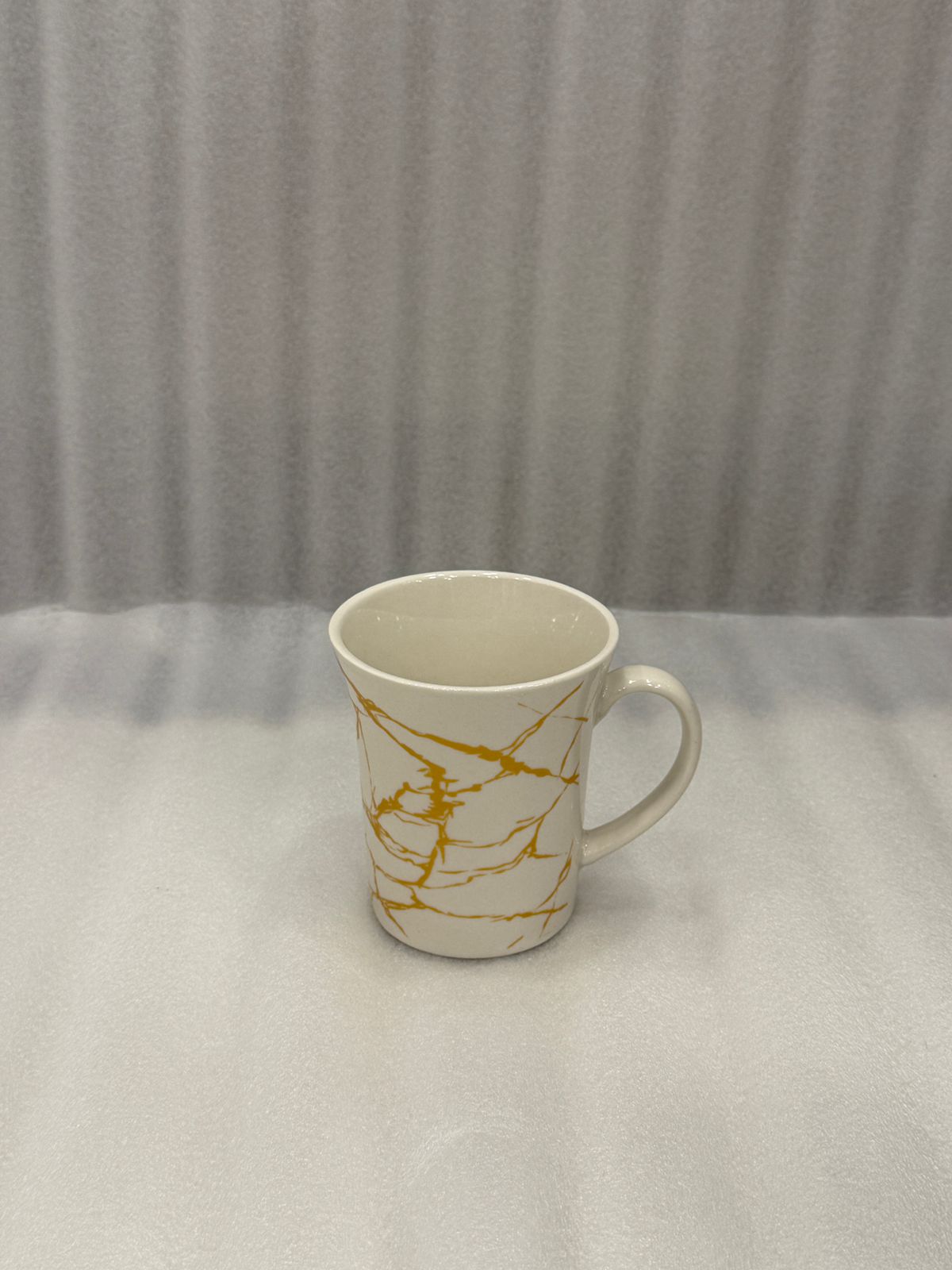 Elegant White Porcelain Tea Cup with Gold Veining