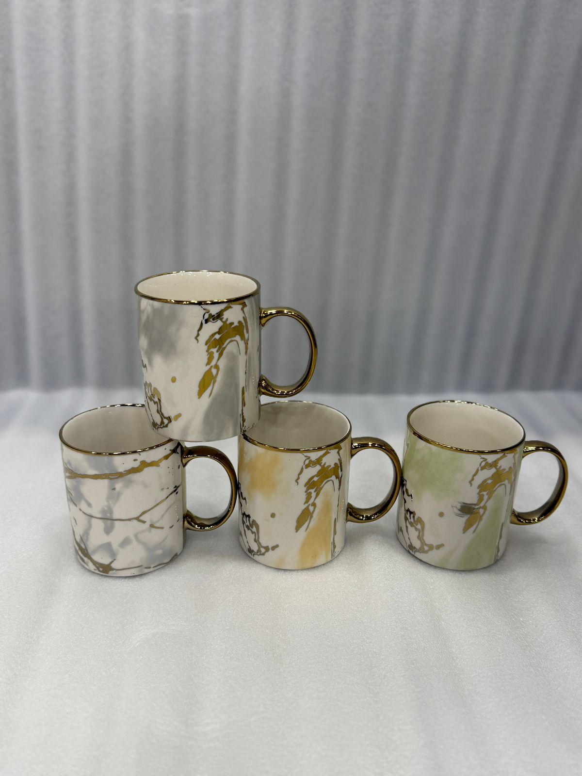 Elegant White and Gold Porcelain Tea Cups with Metallic Handles